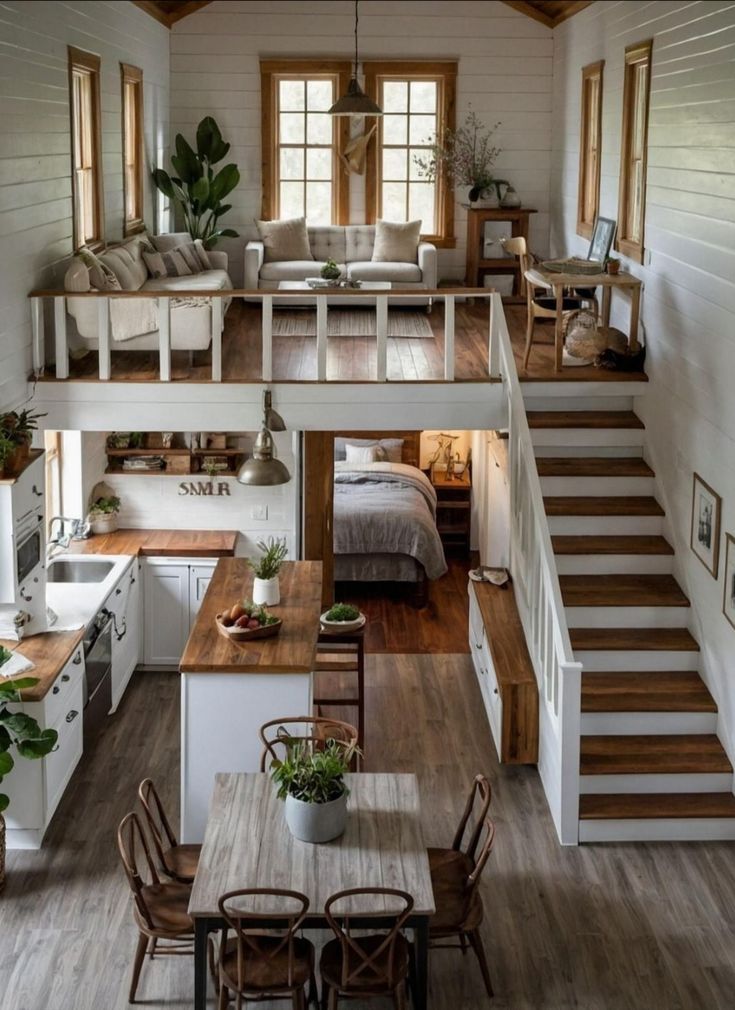 an open floor plan with stairs leading up to the loft