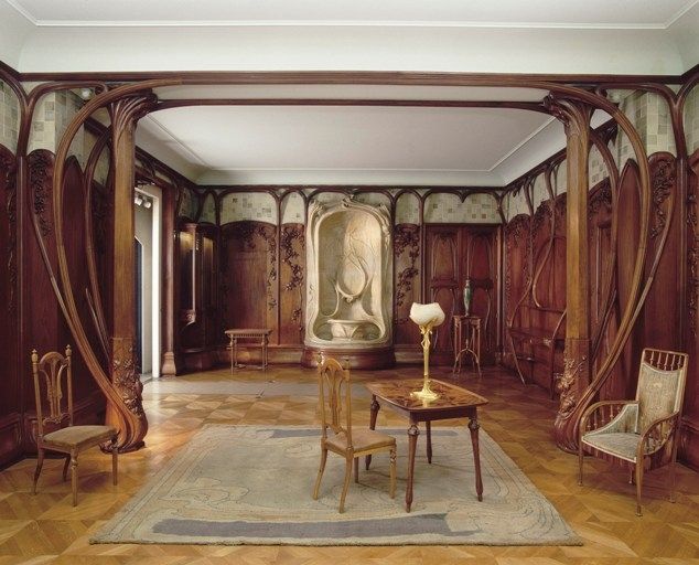 a room with wood paneling and wooden furniture on the floor, along with a large mirror