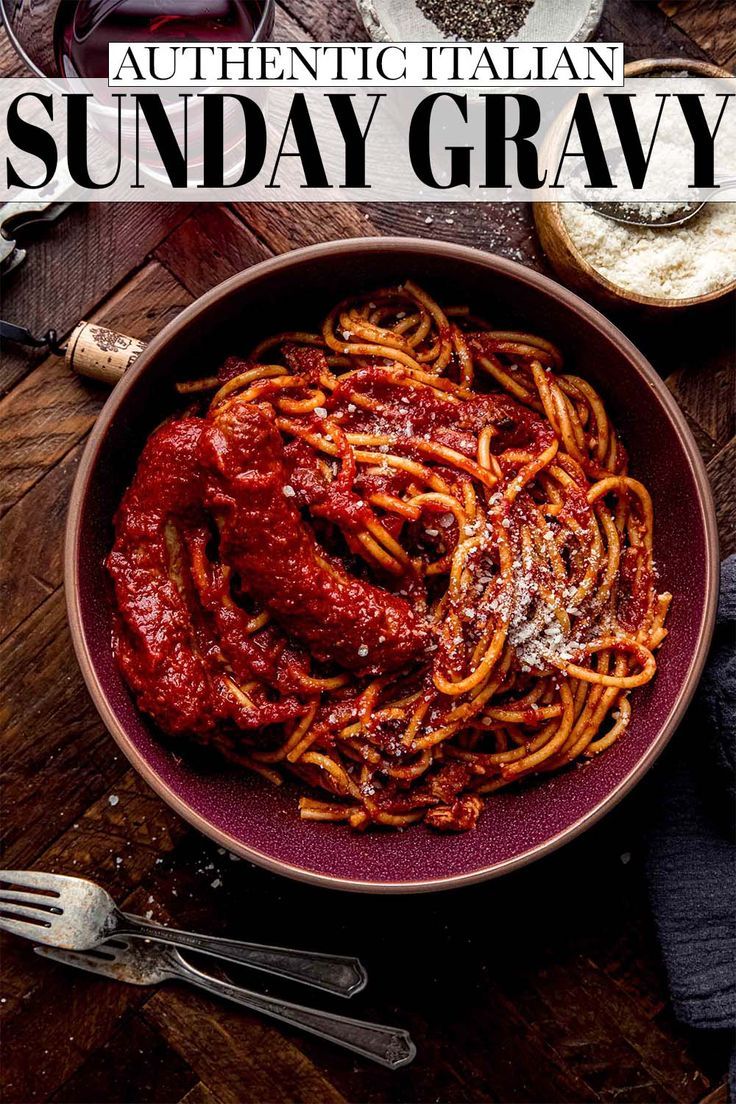 a bowl filled with spaghetti and sauce on top of a wooden table