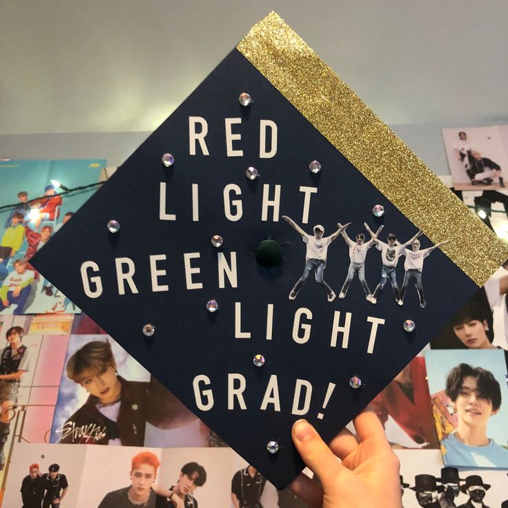 a graduation cap with the words red light green light grad written on it in front of photos