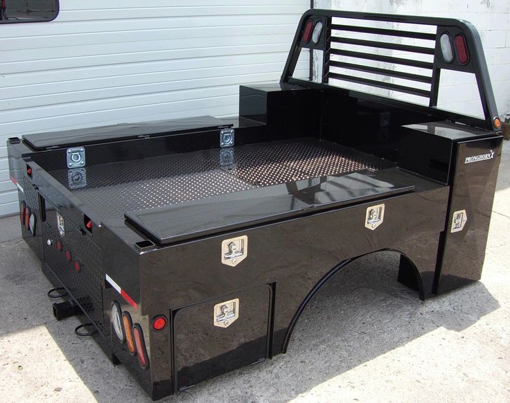 the truck bed has been modified to look like it is parked in front of a garage