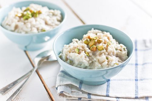 two blue bowls filled with rice on top of a table