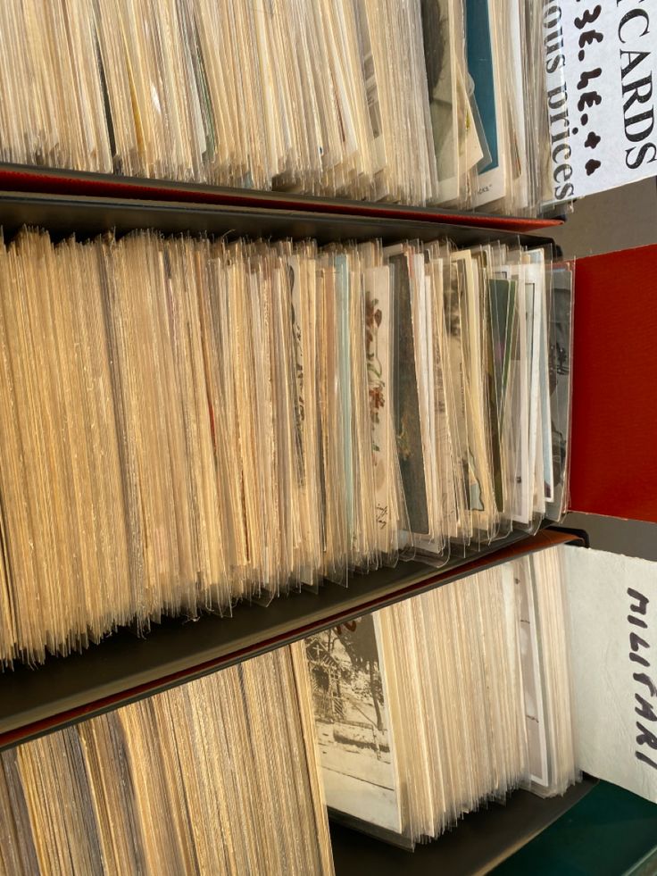 several stacks of records are stacked on shelves