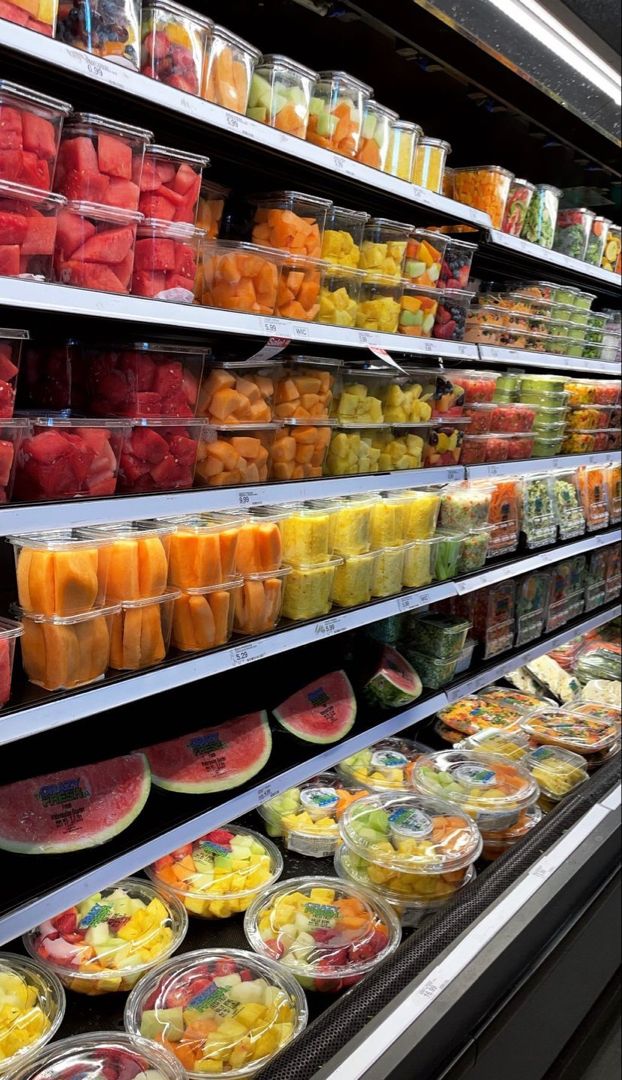 a display in a grocery store filled with lots of fresh fruits and veggies