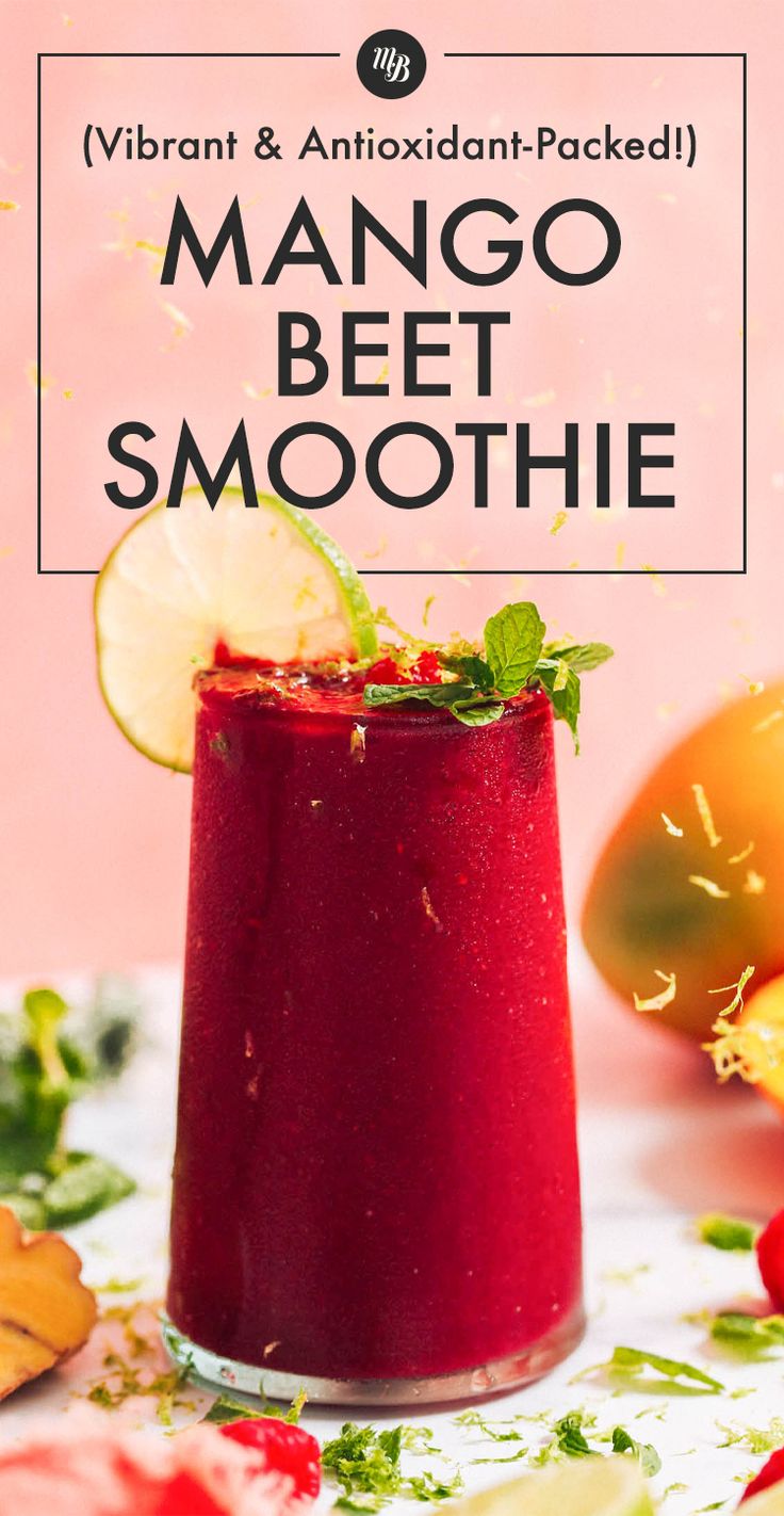 a smoothie in a glass with lime and mint garnish on the side