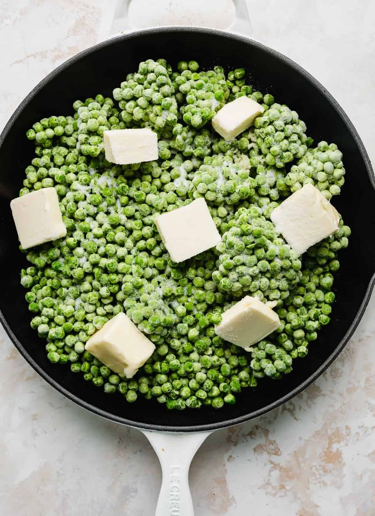 peas and butter in a skillet on a table