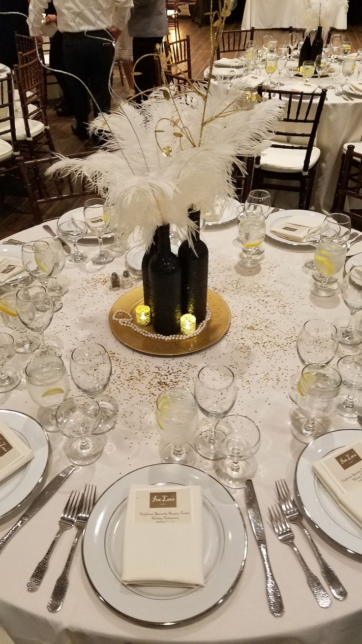 the table is set with white linens, silverware and place settings for dinner