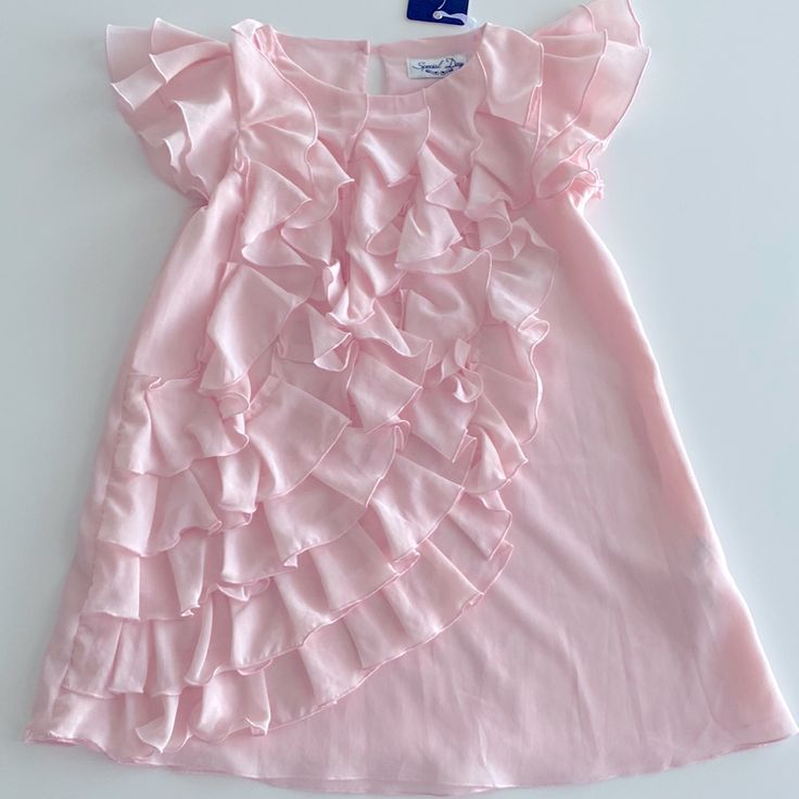 Special Day Ruffles Dress New With Tags Color: Pink Size: 6 Years Old Pink Ruffle Dress For Spring Dress-up, Pink Ruffle Dress For Dress-up Occasions, Pink Ruffle Dress For Dress-up, Pink Ruffle Dress For Spring Formal Occasions, Pink Ruffle Twirl Dress For Spring, Spring Party Twirl Dress With Ruffles, Pink Ruffled Twirl Dress For Spring, Sweet Party Dress With Ruffle Hem, Pink Sleeveless Ruffle Dress For Dress-up