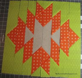 an orange and green piece of fabric next to a cutting board