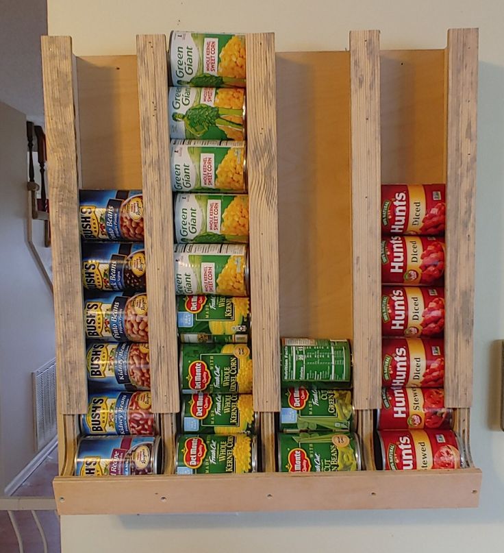 a wooden spice rack with canned food in it