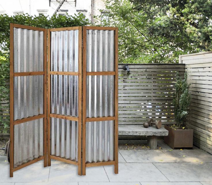 an outdoor room divider made out of wood and metal