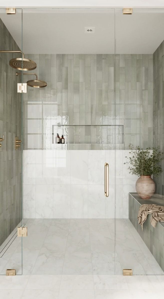 a bathroom with a walk in shower next to a white tiled wall and counter top