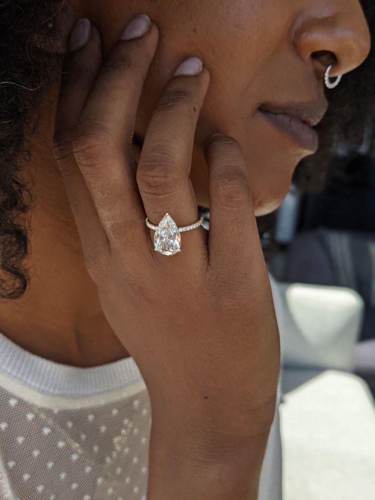 a close up of a person wearing a ring