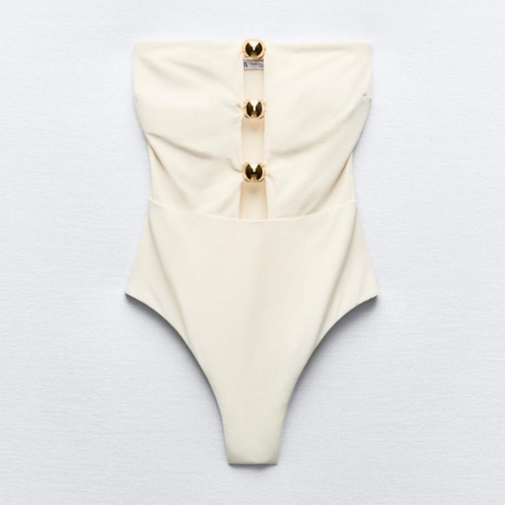 New With Tag Zara 2024 Collection This Item Runs Small Bandeau Swimsuit With Removable Cups. Cut Out Detail And Front Metal Pieces. Interior Lining. Ecru | 0167/214 84% Polyamide 16% Elastane Lining 84% Polyamide 16% Elastane Filling 100% Polyurethane Which Has At Least Outer Shell 84% Rcs-Certified Recycled Polyamide Lining 84% Rcs-Certified Recycled Polyamide Honeymoon Bathing Suit, Wedding Swimsuit, St Lucia Honeymoon, Elegant Swimsuit, White Bathing Suit, Spring Break Outfit, Bandeau Swimsuit, Zara New, White Swimsuit