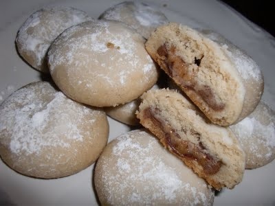 some cookies are on a white plate with powdered sugar