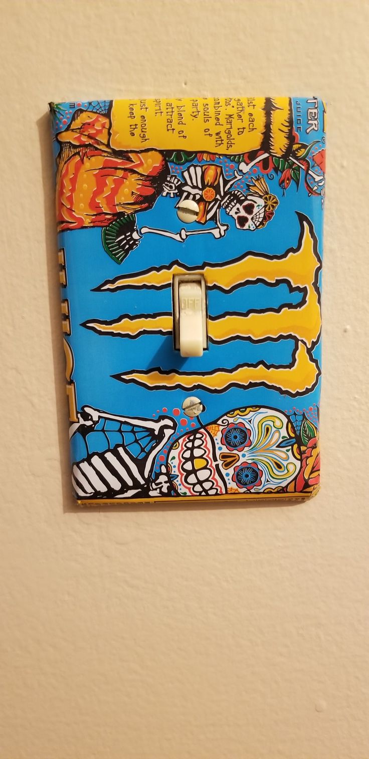 a blue and yellow light switch cover with an image of a cartoon character on it