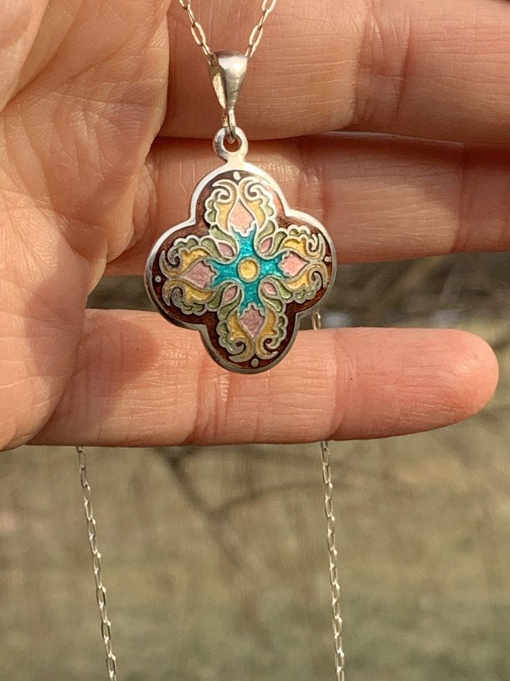 "Enamel Cross Cloisonne Necklace Handmade Religious Fine Sterling Silver Pendant Handmade by me and my 19 year old son in our beautiful Kansas City studio. See our work and follow us on Instagram please. Questions and comments are welcome. Get free shipping when you become our follower. Instagram: https://www.instagram.com/anaraandco/ Tiny fine silver wires bent according the design and then filled with Japanese glass enamel and fired numerous times in the kiln at 1500 degree F. Grinded with dia Handmade Spiritual Jewelry With Flower Pendant, Multicolor Hallmarked Jewelry For Gifts, Multicolor Hallmarked Necklaces As Gift, Multicolor Hallmarked Necklace For Gift, Bohemian Hallmarked Round Pendant Necklace, Spiritual Pendant Necklace With Inlay, Artisan Necklace In Sterling Silver With Artistic Design, Spiritual Sterling Silver Jewelry With Artistic Design, Bohemian Jewelry With Inlay For Gift