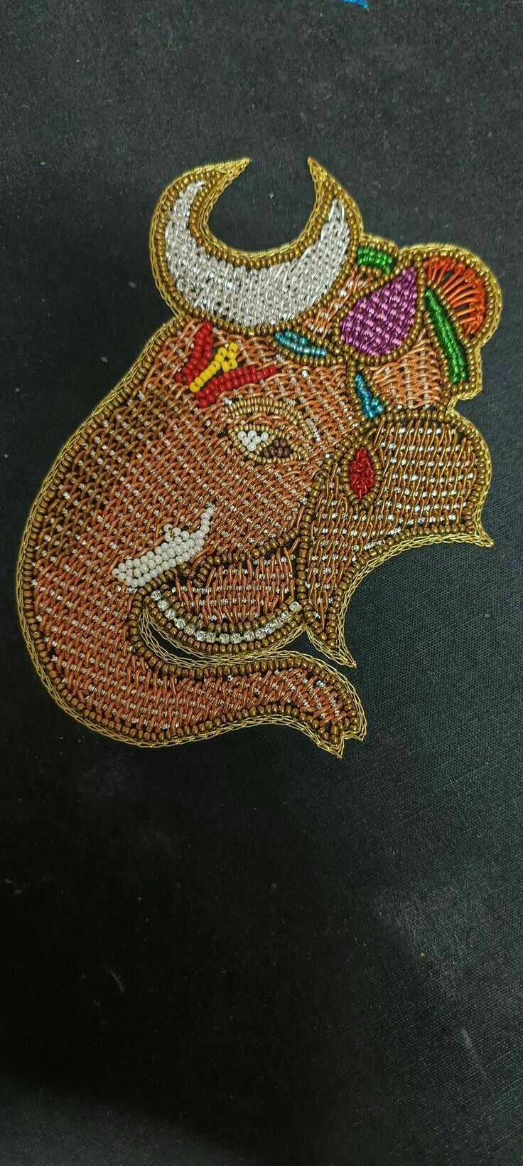 an embroidered bull head on a black background