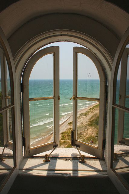 an open window overlooking the beach and ocean