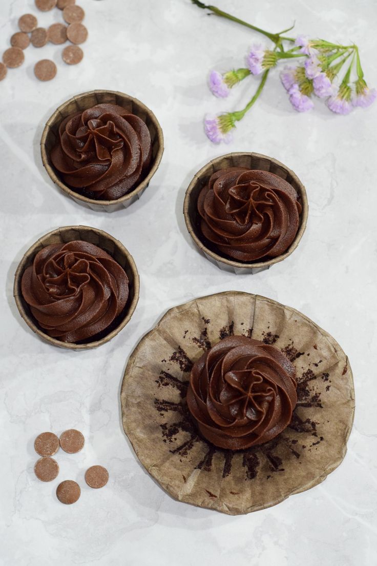 three chocolate cupcakes on top of a paper plate with the words gluten - free chocolate cupcakes