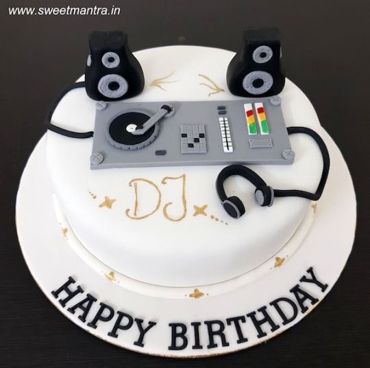 a birthday cake with music equipment on it