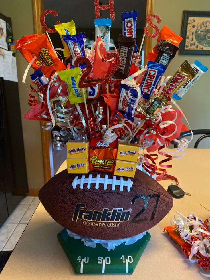 a football themed centerpiece with candy and candies