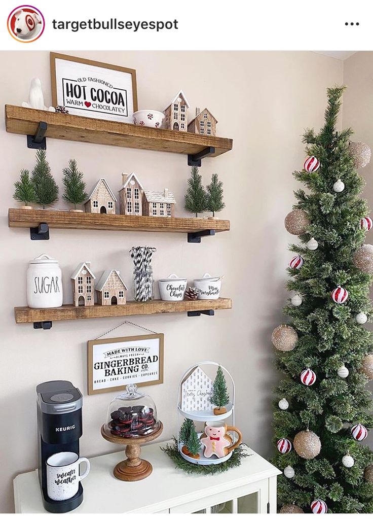 a small christmas tree sitting on top of a white table next to two wooden shelves