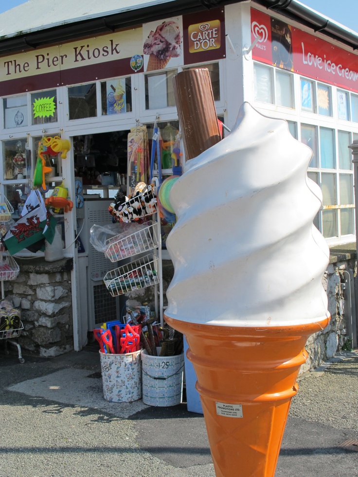 an ice cream cone sitting in front of a store