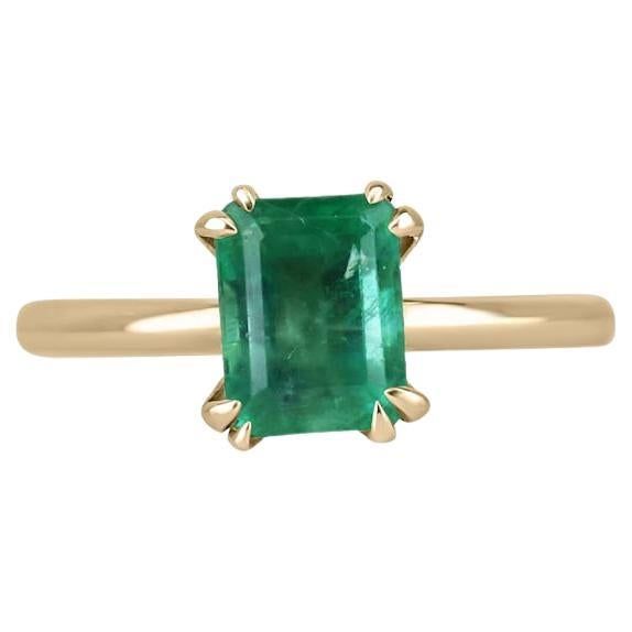 a gold ring with an emerald stone