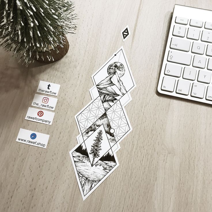 a computer keyboard sitting on top of a wooden desk next to stickers and a potted plant