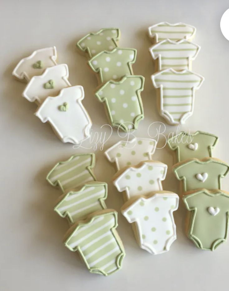 baby ones and ones cookies are arranged on a white table top with green polka dots