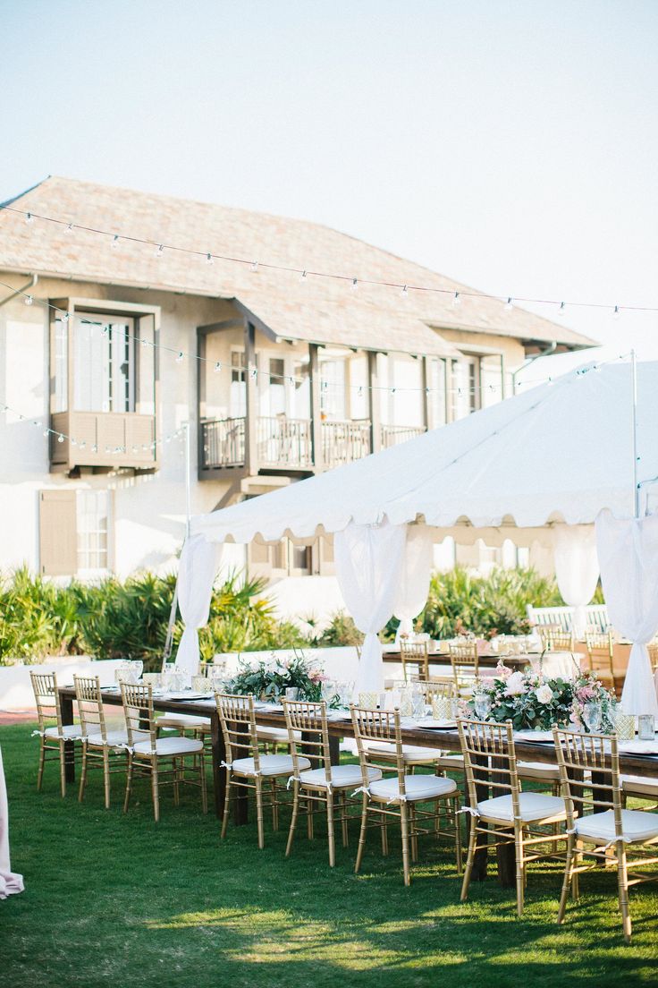 an outdoor wedding setup with tables and chairs