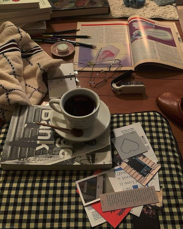 a table topped with books and a cup of coffee