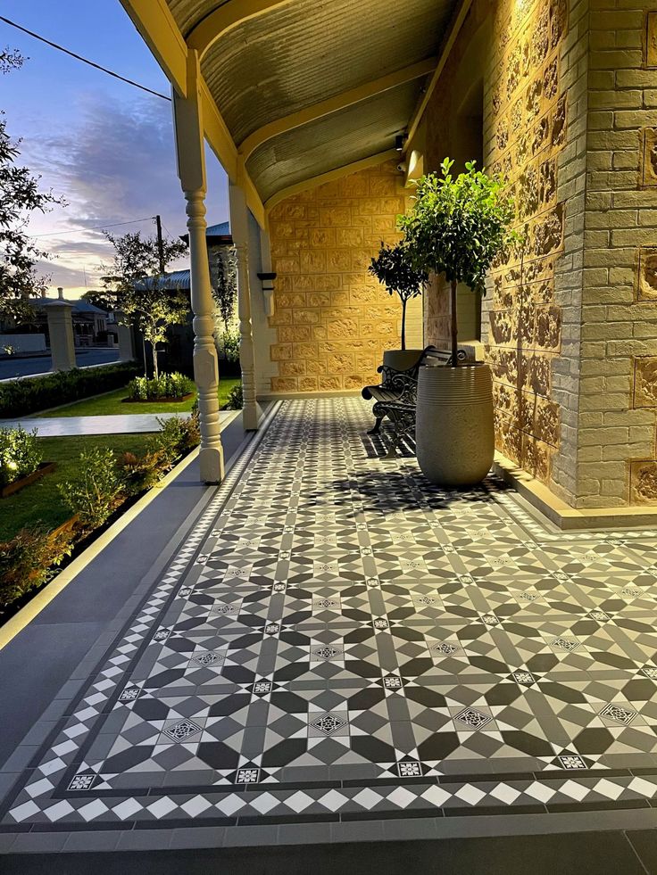 an outdoor walkway with potted plants on the side