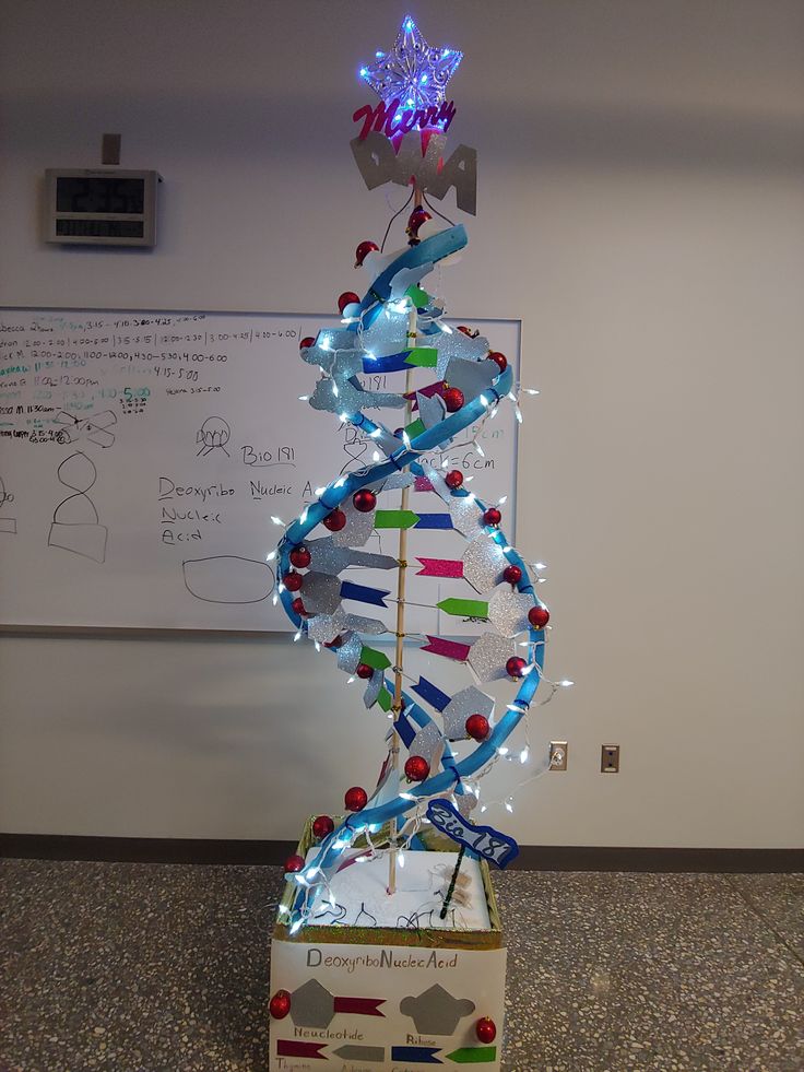 a large model of a structure with lights on it's sides and a spiral staircase in the middle