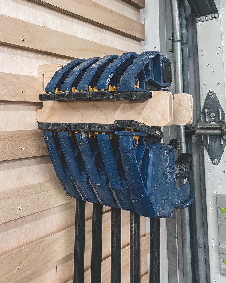 there are many blue buckets attached to the side of a building that is being built