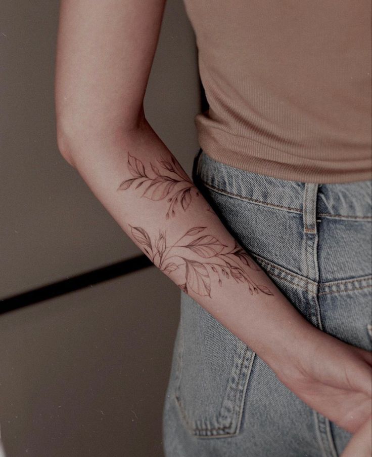 a woman with a flower tattoo on her arm