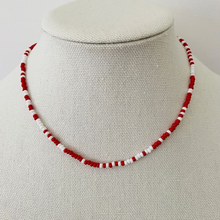 This is the perfect layering necklace. The necklace is beaded with tiny red and white seed beads. It measure approximately 18 inches but can be adjusted up to an inch shorter. Red Seed Bead Jewelry, Diy Red Jewelry, White And Red Bracelets, Tiny Beads Necklace, Red Black And White Beaded Necklace, Red And White Beaded Necklace, Necklace Bead Patterns, Tiny Beaded Necklaces, Ideas For Beaded Necklaces