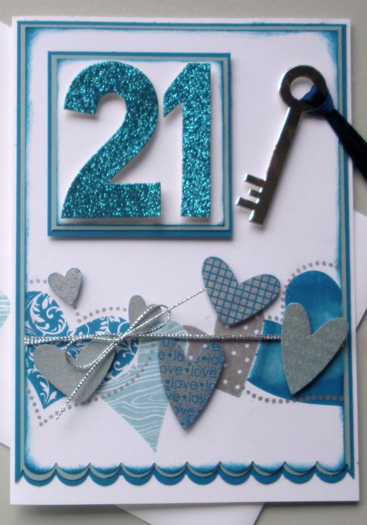 a 21st birthday card with hearts and a key hanging from it's front corner