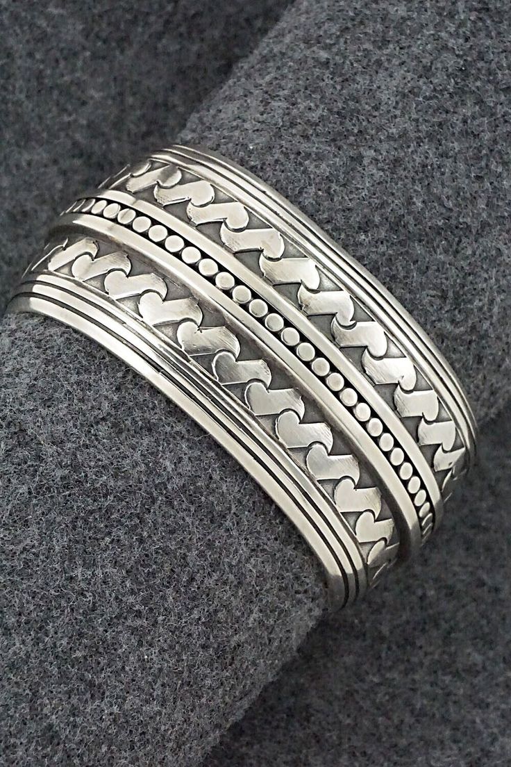 This stunning sterling silver bracelet was made by Navajo silversmith Raymond Delgarito. The back is signed RD and stamped sterling.Size: 5 1/4" (will fit up to a 6 1/4" wrist)Gap: 1"Width: 1 1/4"Free shipping on all orders! We ship with USPS and always include tracking. All orders ship within a day of payment.Returns are accepted up to 30 days after you receive your order. Just send us a message. Our shop offers cash back or store credit. The item must be returned in new condition. Bohemian Sterling Silver Bangle Stamped 925, Bohemian Sterling Silver Bracelet Stamped 925, Etched Sterling Silver Bohemian Bracelet, Bohemian Etched Sterling Silver Bracelet, Native American Jewelry, Free Jewelry, Sterling Silver Bracelets, Silver Bracelet, Stamp