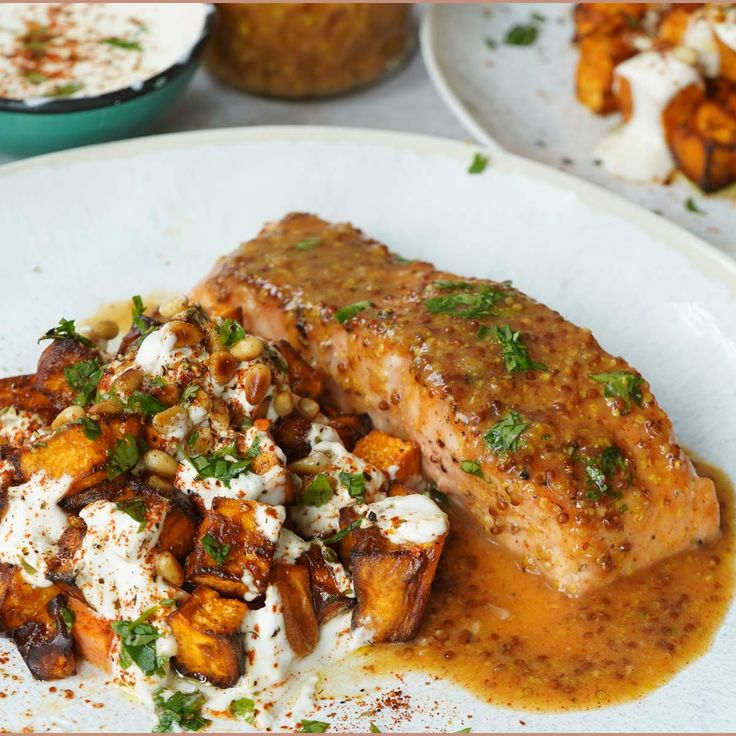 a white plate topped with meat covered in sauce