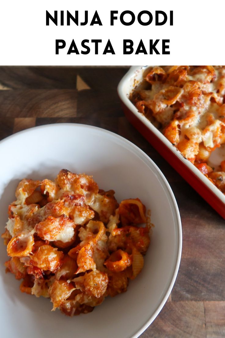 a white plate topped with pasta next to a red casserole dish on top of a wooden table