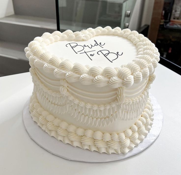 a white cake with the words bride to be written on it sitting on a table