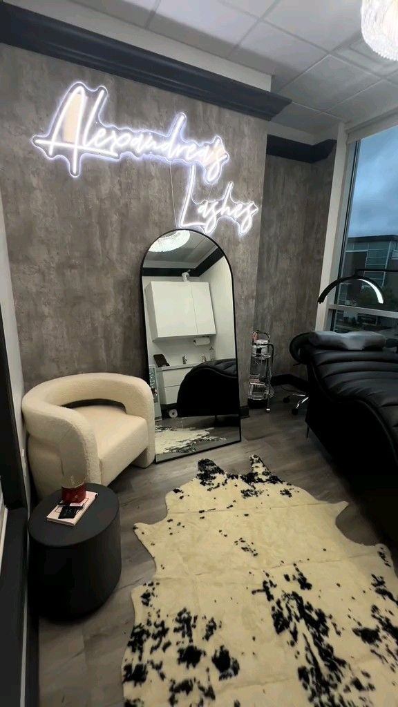 a room with a chair, mirror and hair dryer