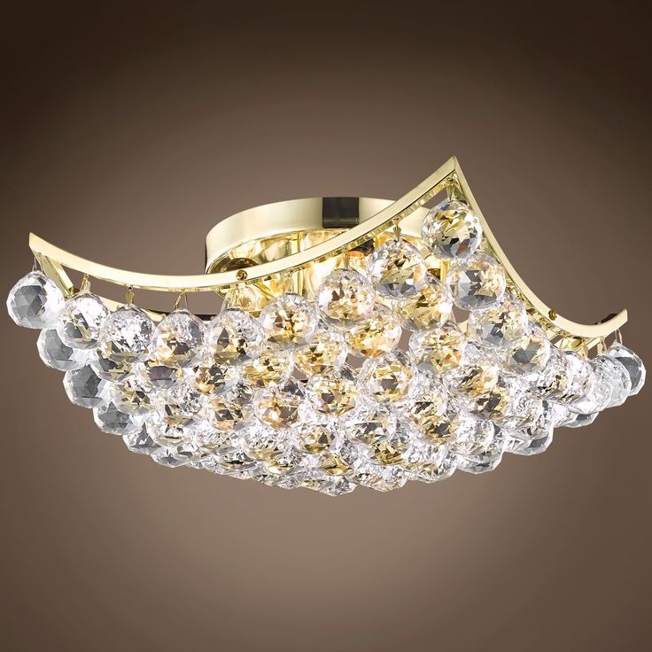 a gold and crystal flush light fixture on a brown background