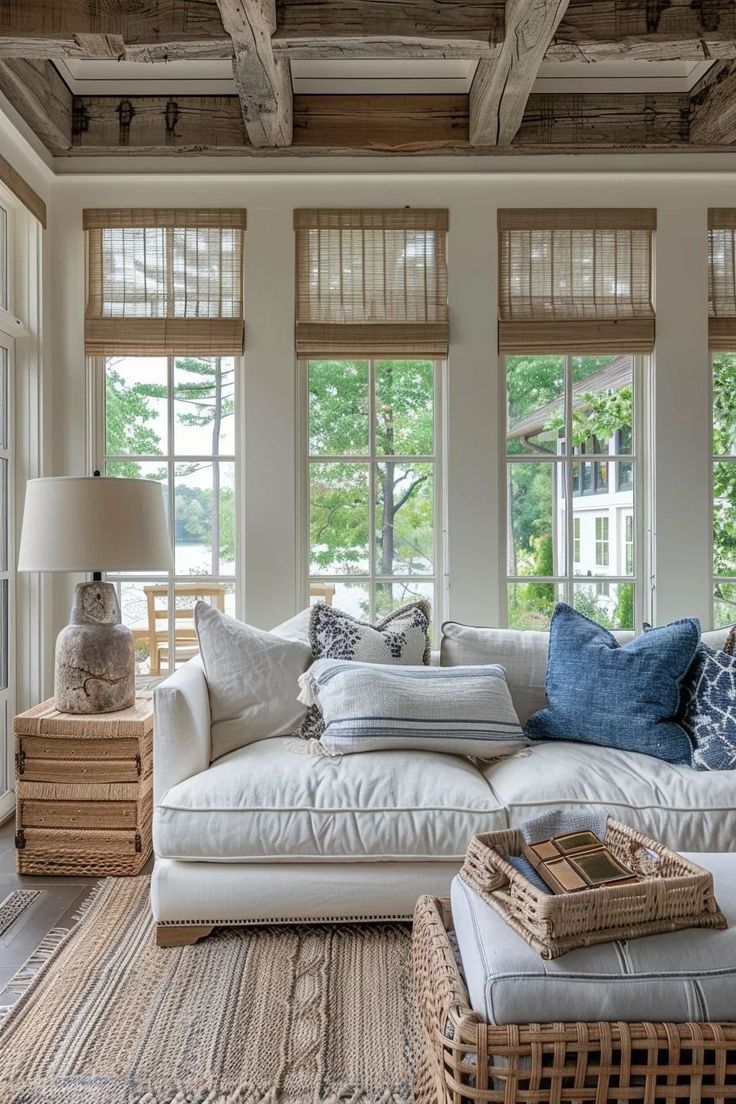 a living room filled with furniture and lots of windows