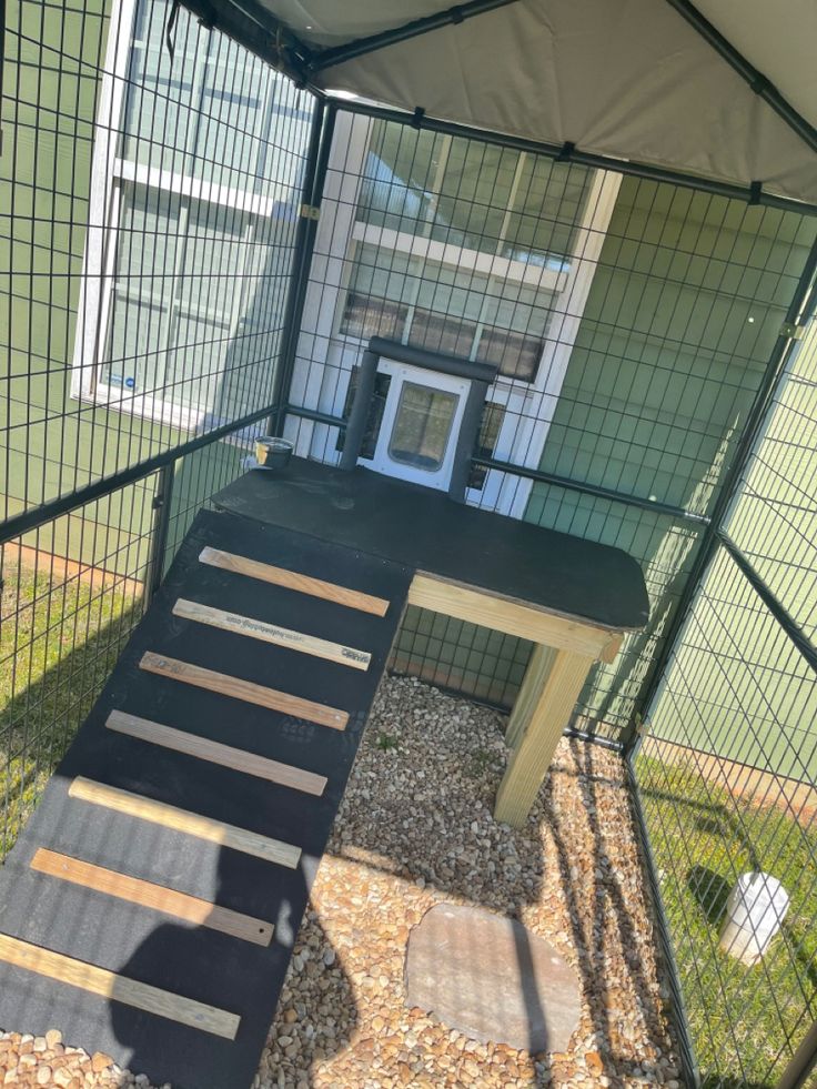 an outdoor play area with stairs leading up to the door and on top of it