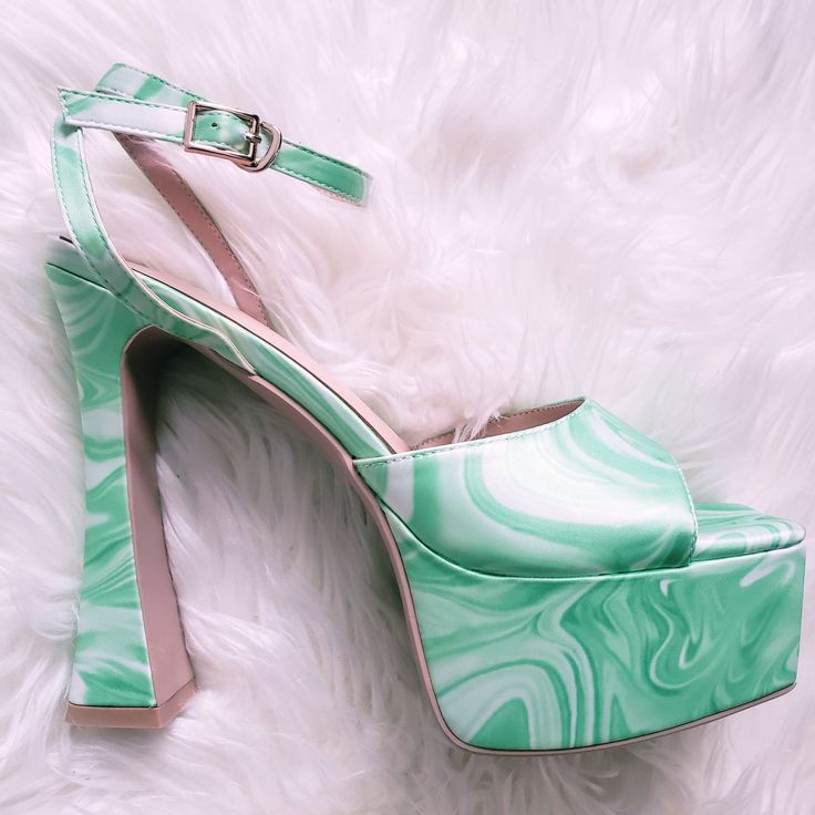 Introducing our retro-inspired platform heels, featuring a mesmerizing swirl marble print in purple or green. Crafted with lustrous satin material, these groovy heels have a secure ankle strap, flared heel, and open toe design, allowing you to embrace your inner 70’s diva with every step. Vibrant swirl marble print Lustrous satin material for a luxurious feel Secure ankle strap for a perfect fit Flared heel & open toe design adds a funky twist Heel height is 5.5 inches Red Sparkly Heels, Teal Pumps, Christian Louboutin Iriza, Cheetah Print Heels, Gold Strappy Heels, Michael Kors Heels, Red Louboutin, Sparkly Heels, Jimmy Choo Heels