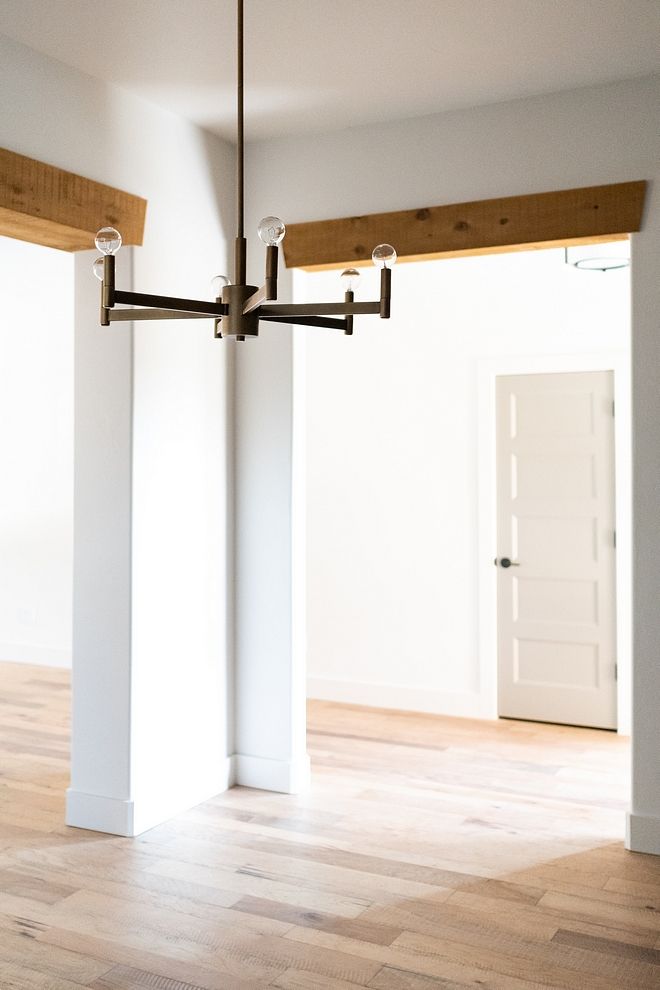 an empty room with white walls and wooden floors