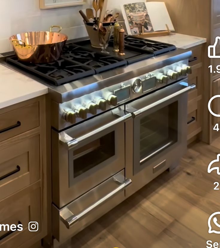 an image of a kitchen setting with stainless steel ovens and stove top in the middle